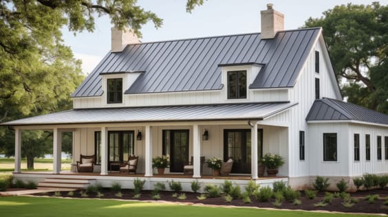 Two-storey white barndominium with a wraparound porch